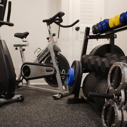 Mike's private gym with spin bike and weights