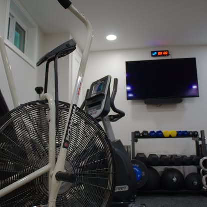 Private gym with assault bike and dumbbells